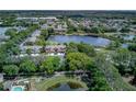 Gorgeous aerial shot of the community next to a lake and matured trees, providing serene landscape views at 8419 Chamberlain Pl, Oviedo, FL 32765
