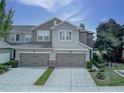 Charming two-story townhome featuring two-car garage, neutral paint, and beautiful architectural details at 8419 Chamberlain Pl, Oviedo, FL 32765