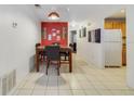 Eat-in dining area features tile floors and a striking red accent wall with stylish decor at 9231 Ventana Ln, Orlando, FL 32825