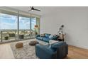 Open living room features a neutral rug, hardwood floors and a balcony with spectacular city views at 150 E Robinson St # 2506, Orlando, FL 32801