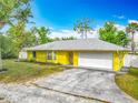 Bright yellow home with a well-manicured lawn and a welcoming entrance at 110 Riverside Ter, Edgewater, FL 32141