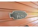 Close-up of a 'Thornton Park Built 1925' plaque on the exterior of the house at 117 N Thornton Ave, Orlando, FL 32801
