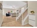 Bright, open living space featuring neutral carpet, a staircase, and comfortable seating at 987 Alston Bay Blvd, Apopka, FL 32703