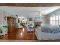 Bright living room with hardwood floors, a brick fireplace, and plantation shutters, creating a cozy atmosphere at 1000 E Anderson St, Orlando, FL 32801