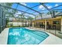 Backyard pool area featuring a screened enclosure, safety fence and outdoor seating at 10119 Bayard Ct, Orlando, FL 32836