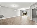 Open-concept living area with a sliding glass door and an elegant chandelier at 10743 Belfry Cir, Orlando, FL 32832