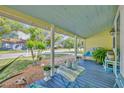 Serene front porch with light blue ceiling, table, and seating offering a relaxing outdoor space at 1110 Virginia Ave, St Cloud, FL 34769