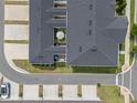 Aerial shot of townhome roofs and rear courtyards, some featuring patio furniture and umbrellas at 1324 Painted Bunting Ave, Oakland, FL 34787