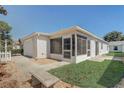 Exterior view of home with screen enclosed lanai and vinyl siding at 1461 Sothell St, The Villages, FL 32162