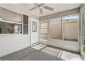 Enclosed sunroom featuring an outdoor entry door and multiple windows for natural light at 1461 Sothell St, The Villages, FL 32162