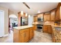 Modern kitchen with stainless steel appliances, center island, granite countertops and wooden cabinets at 2020 Corner Glen Dr, Orlando, FL 32820