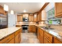 Beautiful kitchen with granite countertops, tile floors, stainless steel appliances and ample wooden cabinetry at 2020 Corner Glen Dr, Orlando, FL 32820
