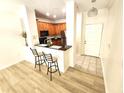 Open concept kitchen area boasts wood cabinets, black countertops and stainless steel appliances at 2528 Robert Trent Jones Dr # 1617, Orlando, FL 32835