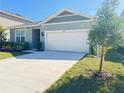 Inviting single-story home with a well-manicured lawn and a two-car garage at 2731 Forestdale St, St Cloud, FL 34771