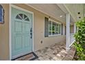 Charming front door with decorative glass and covered porch at 303 W Par St, Orlando, FL 32804