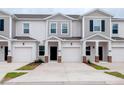 New townhomes featuring individual garages and lovely architectural details, offering modern comfort and curb appeal at 3239 Laurent Loop, Davenport, FL 33837