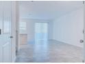 Bright living room features an open floor plan and a sliding glass door, perfect for modern living at 3239 Laurent Loop, Davenport, FL 33837