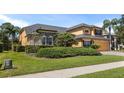 Stunning home with meticulously maintained landscaping, lush green lawn, and beautiful architectural details at 3418 Turningwind Ln, Winter Garden, FL 34787