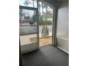 View from enclosed porch of a parking area with trees in the distance at 3530 Forest Branch Dr # F, Port Orange, FL 32129