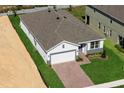 New construction home with gray roof and driveway, and lawn at 364 Lemongrass Rd, Minneola, FL 34715