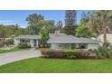 Landscaped front yard and driveway leading up to the charming single-story home at 4436 Larado Pl, Orlando, FL 32812