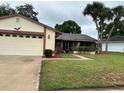 Lovely single-story home with a two-car garage, well-maintained lawn, and mature palm trees at 5120 Lazy Lake Cir, Orlando, FL 32821