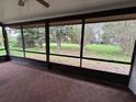 Spacious screened-in porch with views of the lush backyard, perfect for outdoor relaxation at 5120 Lazy Lake Cir, Orlando, FL 32821