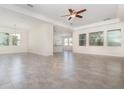 Bright living room features tile flooring, ample natural light from many windows, and a modern ceiling fan at 5871 Alenlon Way, Mount Dora, FL 32757