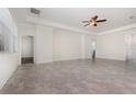 Spacious living room boasts tile floors, neutral paint, large windows, and a stylish ceiling fan at 5871 Alenlon Way, Mount Dora, FL 32757