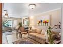 Comfortable living room with a cream sofa, artwork, and views of the neighborhood at 611 Green Briar Blvd, Altamonte Springs, FL 32714
