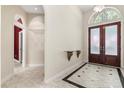 Elegant foyer with marble floors, high ceilings, and a decorative front door at 612 Stonefield Loop, Lake Mary, FL 32746