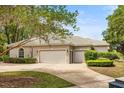 Spacious three-car garage with neutral paint and well-maintained landscaping adding curb appeal at 612 Stonefield Loop, Lake Mary, FL 32746