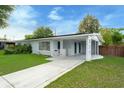 Inviting single-story home featuring a spacious carport, well-kept lawn, and a freshly painted facade at 6431 Greylynne St, Orlando, FL 32807