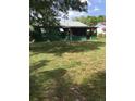 Spacious backyard featuring green grass and view of the back of house with screened in back porch at 710 W Swoope W Ave, Winter Park, FL 32789