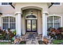 Close-up of the front door, featuring a brick walkway and manicured landscaping at 772 Pickfair Ter, Lake Mary, FL 32746