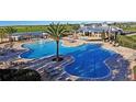 Expansive community pool area with lounge chairs, a water park, and a clubhouse at 7809 Purple Finch St, Winter Garden, FL 34787