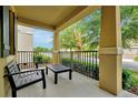 Relaxing front porch with outdoor seating and views of the landscaped yard at 7809 Purple Finch St, Winter Garden, FL 34787