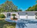 Well-maintained home with a front gate, walkway and two-car garage at 1228 Vantage Dr, Orlando, FL 32806