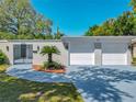 Charming home featuring a front gate, walkway and two-car garage at 1228 Vantage Dr, Orlando, FL 32806