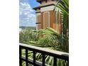 An interesting building view is shown behind the palm trees on a sunny day at 12527 Floridays Resort Dr # 311E, Orlando, FL 32821