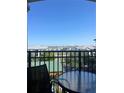 View from balcony shows a metal table and chair with a cityscape view in the background at 12527 Floridays Resort Dr # 603E, Orlando, FL 32821