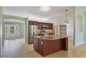 Open kitchen featuring granite countertops, stainless steel appliances, and a large island at 1819 E Chapel Dr, Deltona, FL 32738