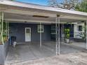 Carport with support beams, ample parking, and potential for outdoor entertaining and convenient home access at 3407 Silverwood Dr, Orlando, FL 32808