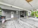 Carport with support beams and concrete flooring, offering convenient covered parking and easy access to the home at 3407 Silverwood Dr, Orlando, FL 32808