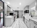 Open kitchen design with a large island, stainless steel appliances, and modern fixtures at 3407 Silverwood Dr, Orlando, FL 32808