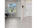 Bright entryway features neutral tile flooring and natural light from the window, creating a welcoming atmosphere at 5553 Turkey Creek Way, Lakeland, FL 33811