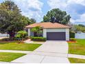 Beautiful single-Gathering home with a well-manicured lawn, mature trees, and a large driveway at 8023 Canyon Lake Cir, Orlando, FL 32835
