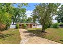 Inviting single-story home with mature landscaping and a long driveway at 1219 Helen St, Apopka, FL 32703