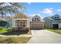 Lovely single-Gathering home with a manicured lawn and a convenient two-car garage on a sunny day at 14720 Sweet Acacia Dr, Orlando, FL 32828