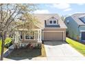 Cozy single-Gathering home boasting a well-kept lawn and an attached two-car garage on a bright day at 14720 Sweet Acacia Dr, Orlando, FL 32828